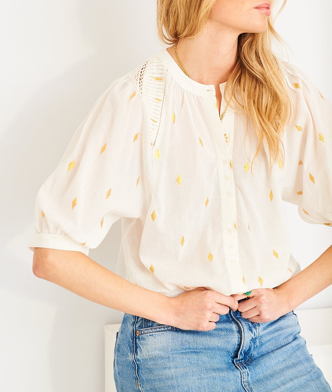 White cotton blouse with lace inserts and gold embroidery from wardrobe 44.